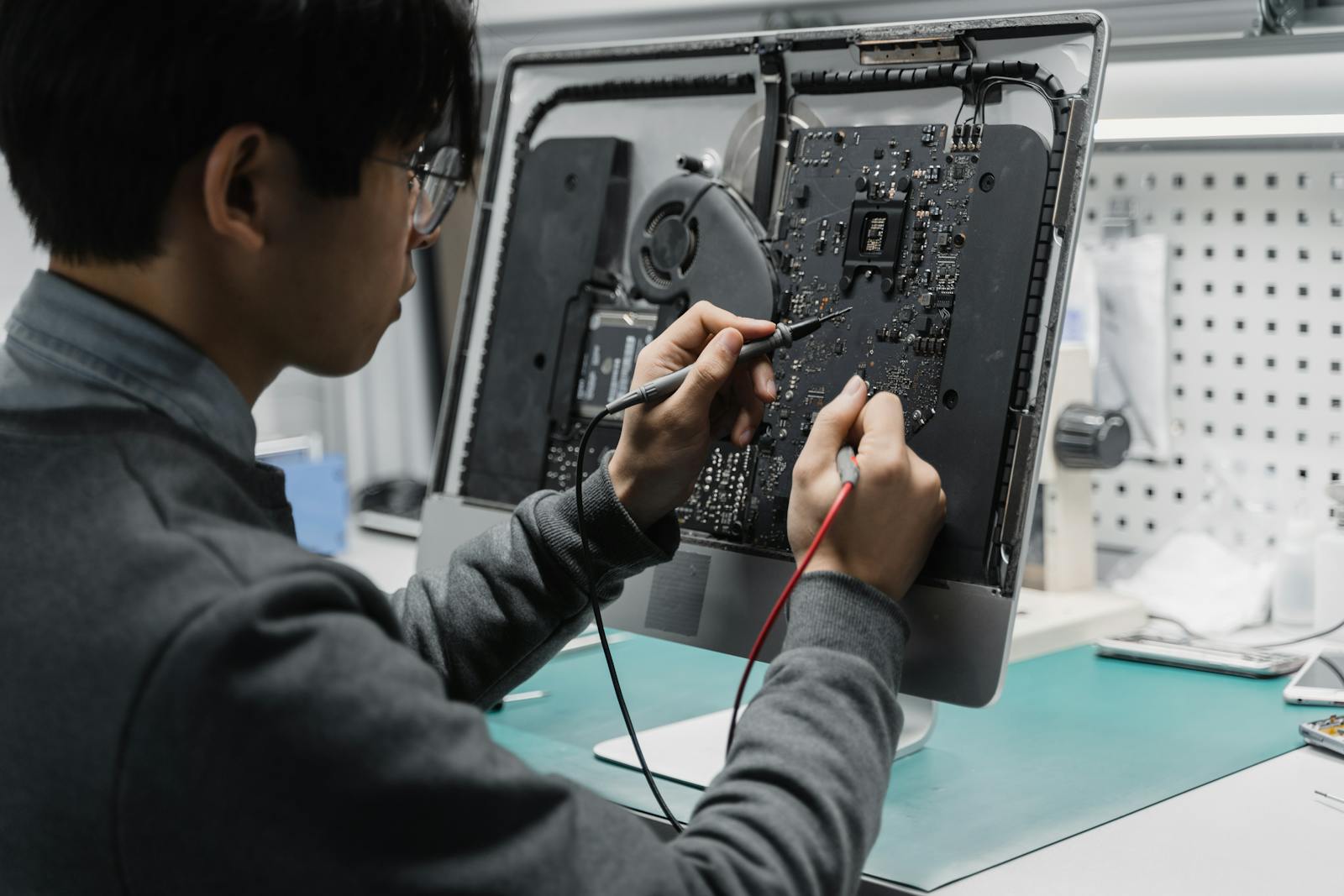Computer motherboard inspection on a repair bench