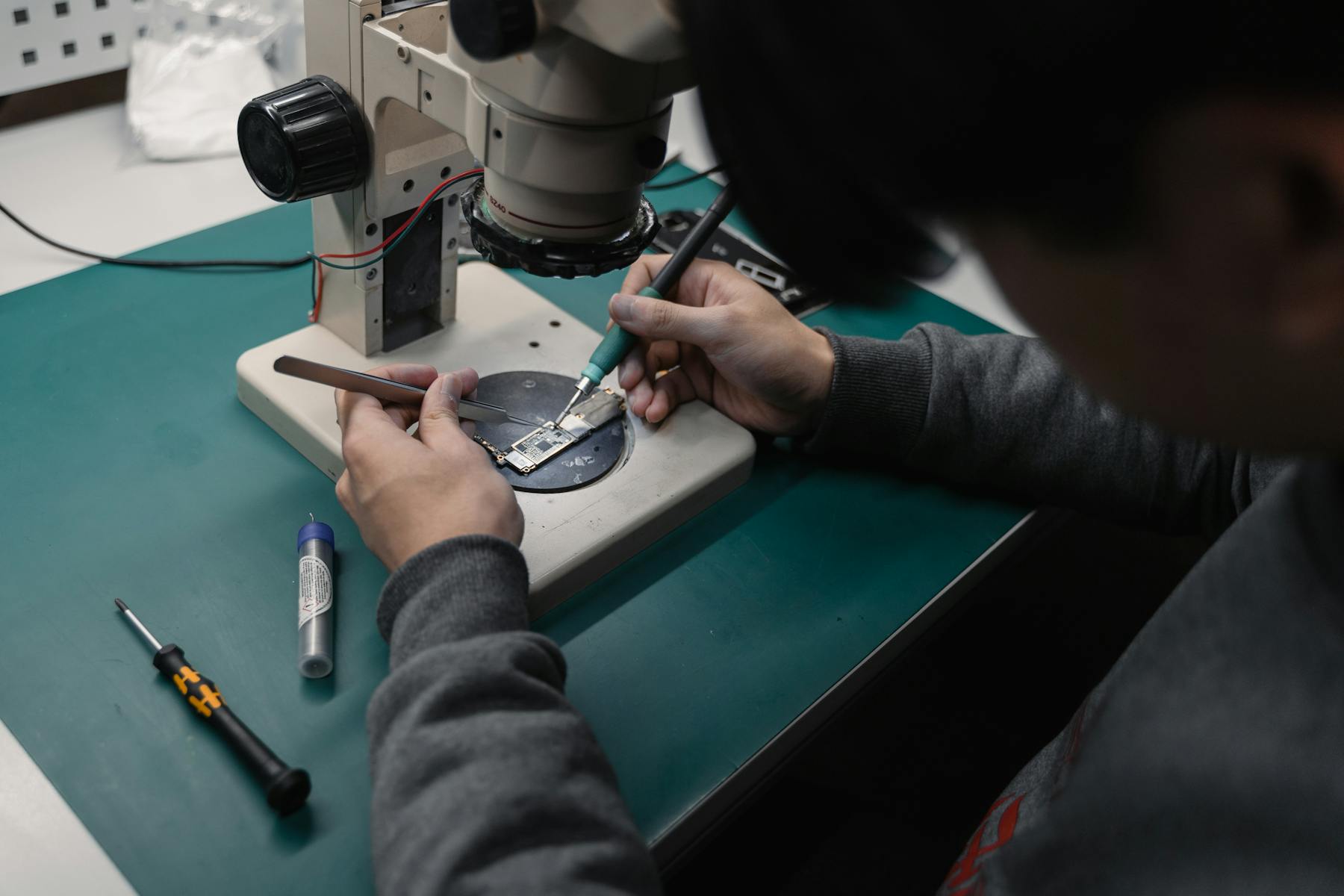 Circuit board being inspected under a microscope