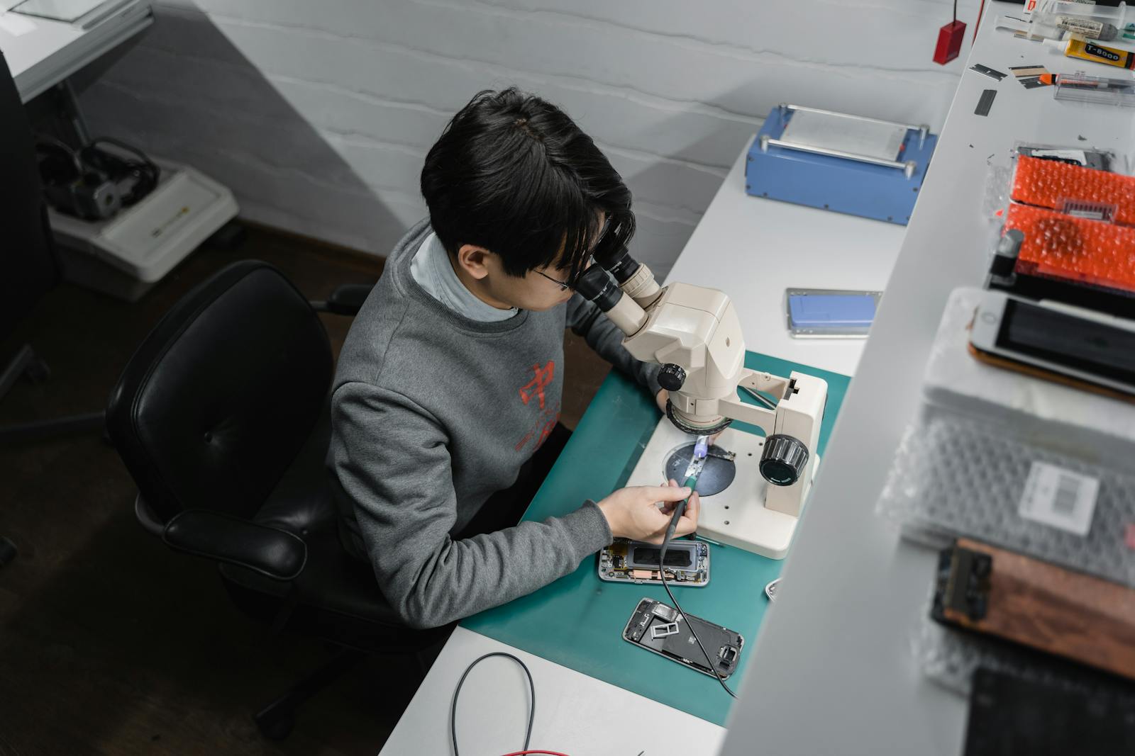 Smartphone opened on a precision repair bench